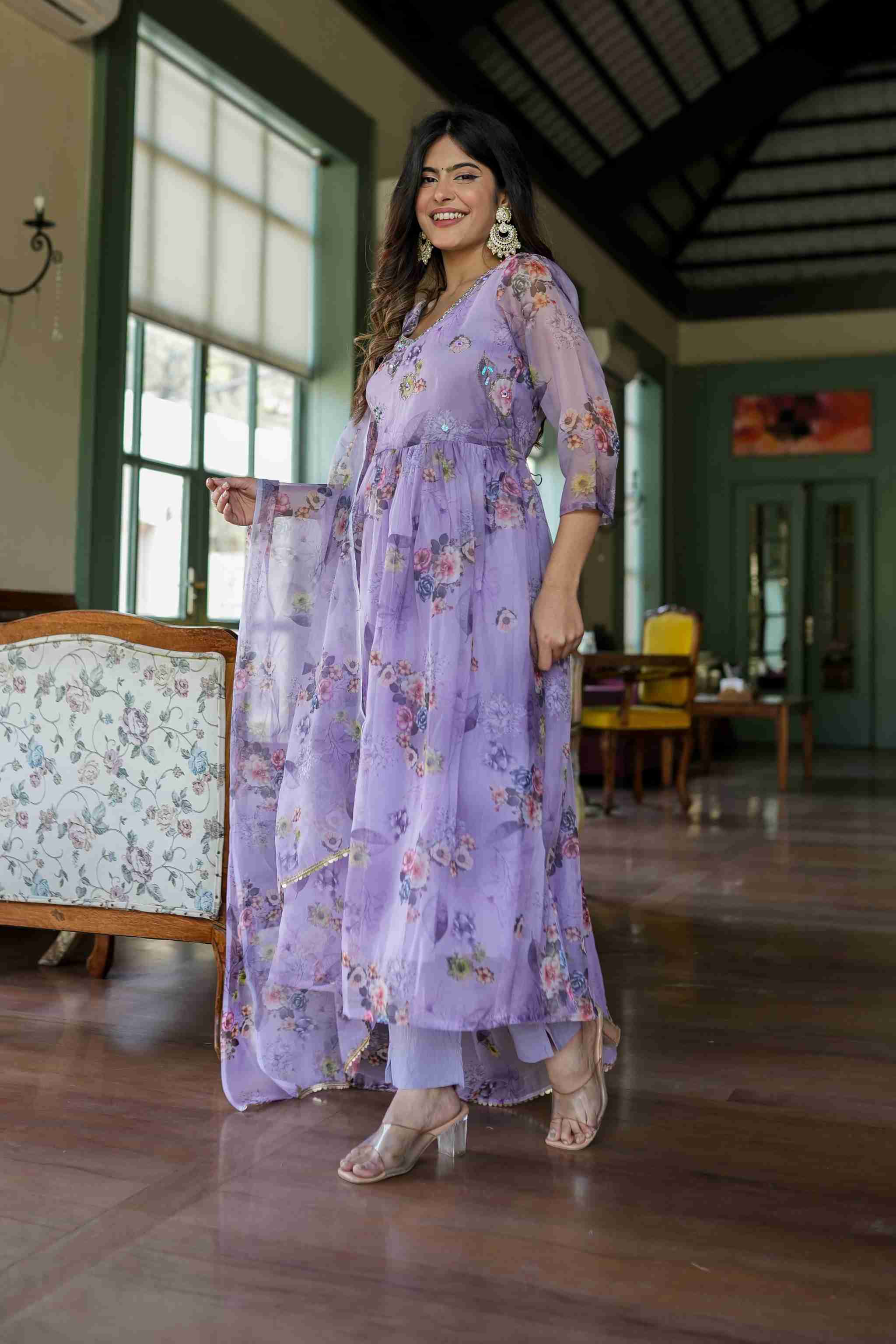 Organza Anarkali suit set adorned with elegant purple floral motifs.