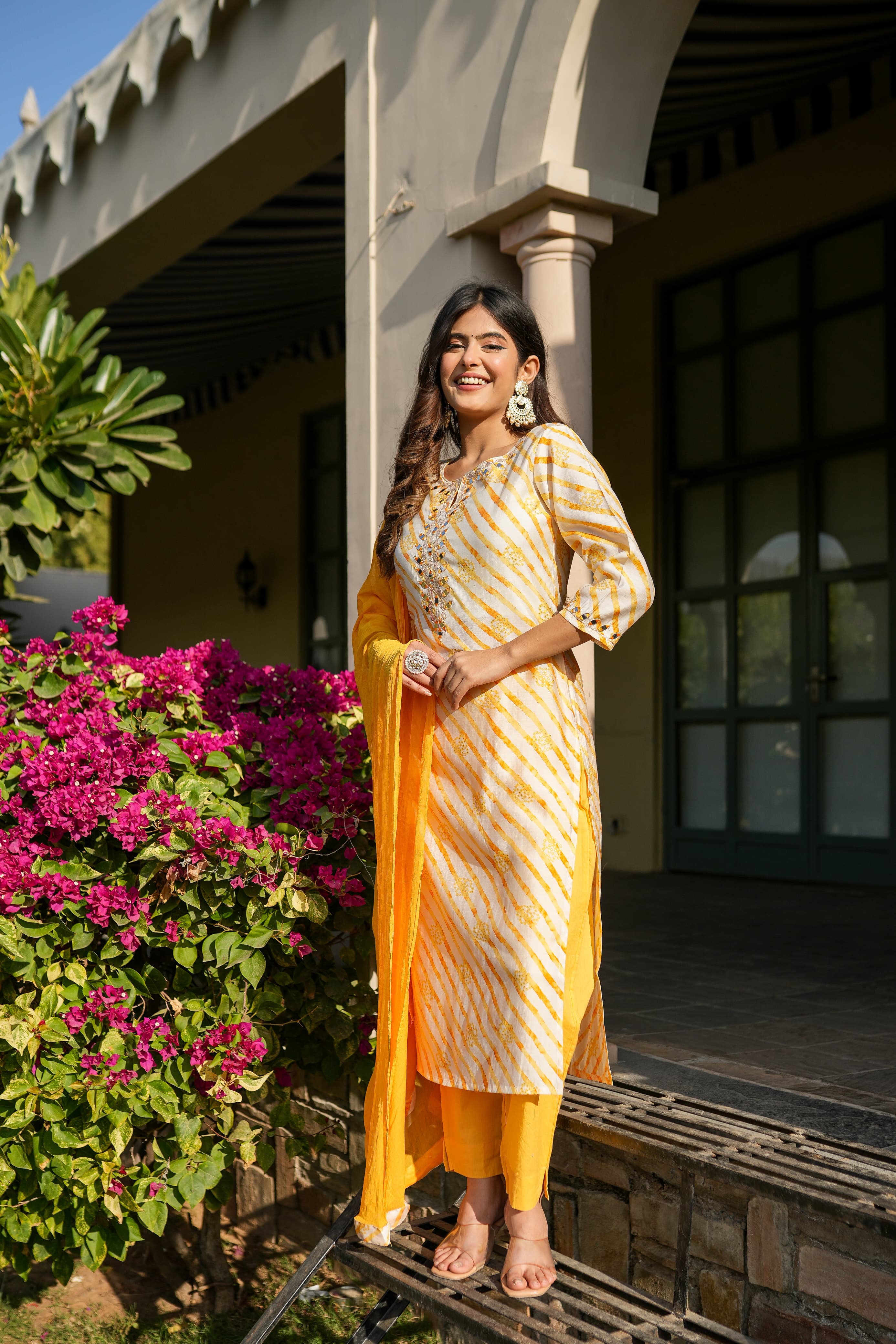 Yellow leheriya straight kurta set with mirror work