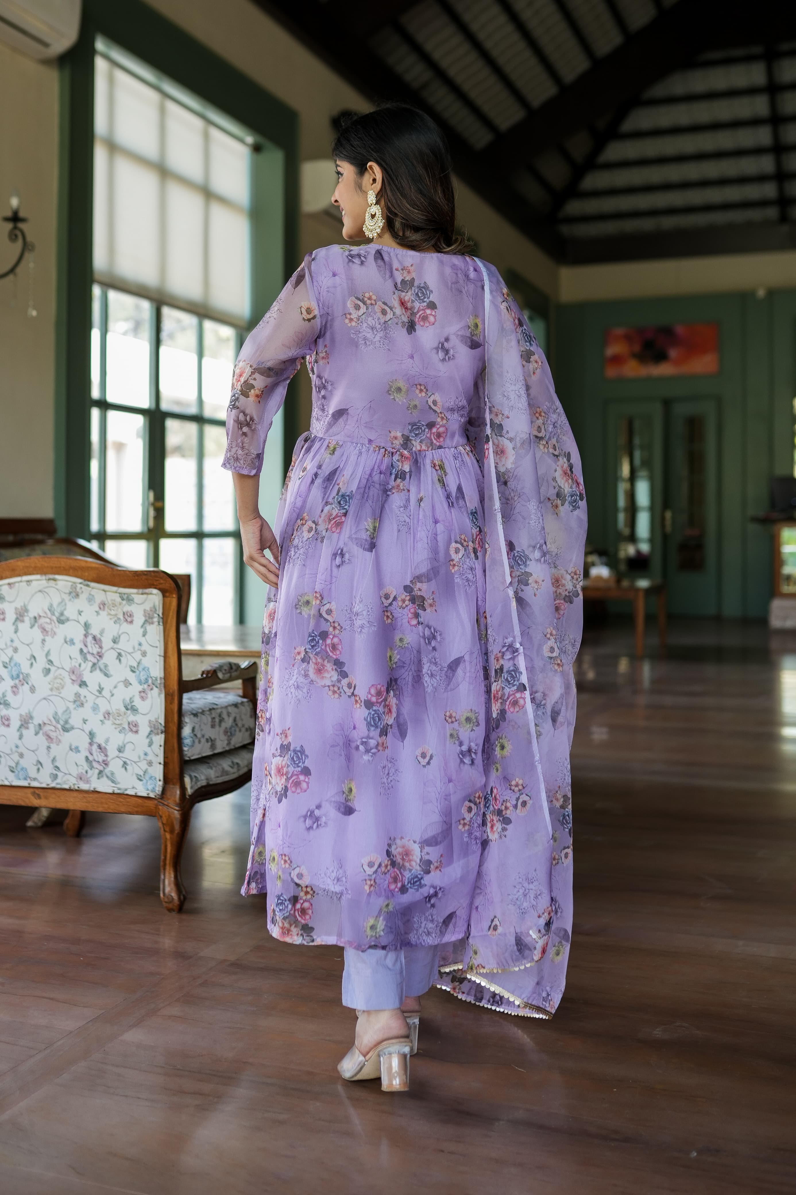 Organza Anarkali suit set adorned with elegant purple floral motifs.