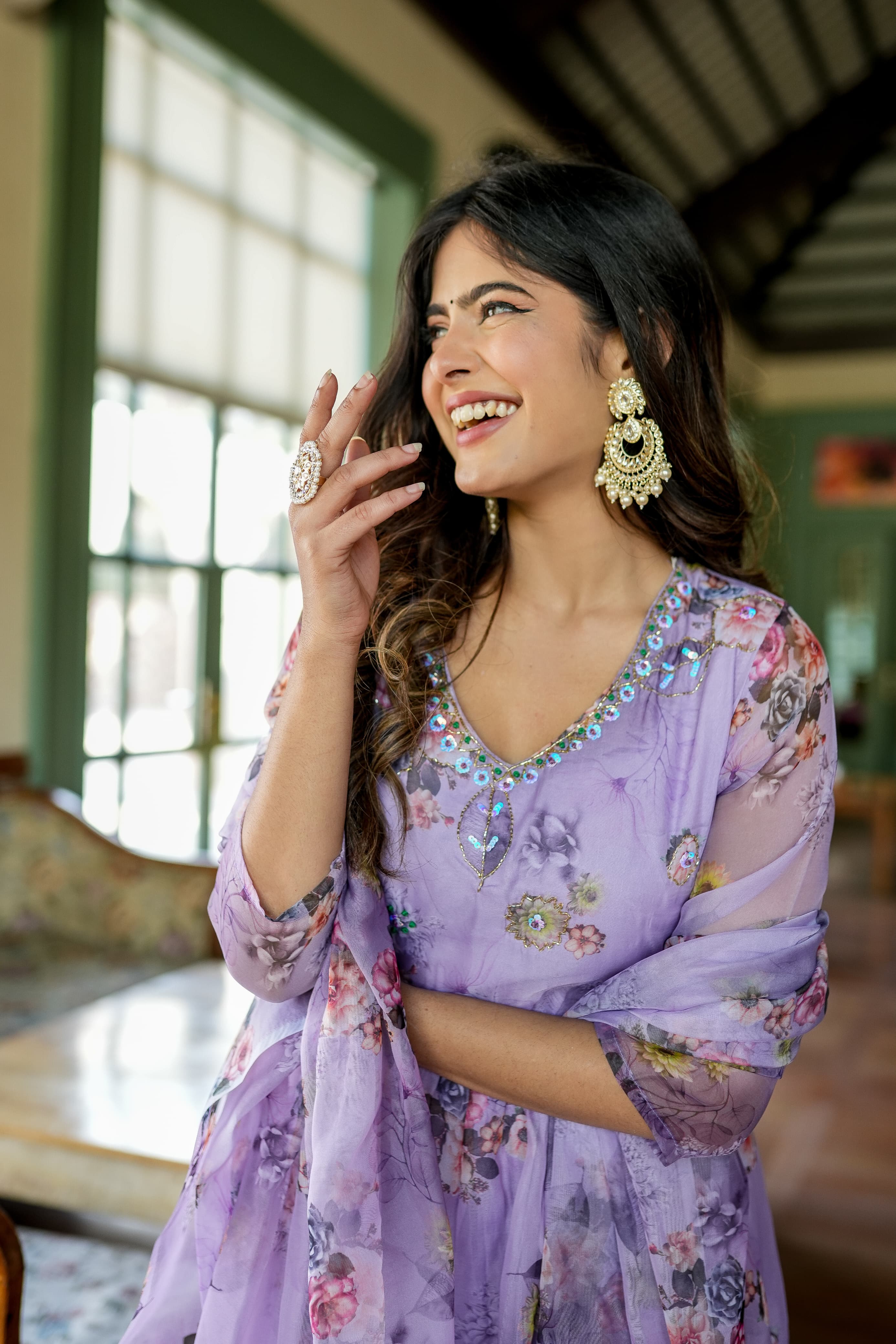 Organza Anarkali suit set adorned with elegant purple floral motifs.